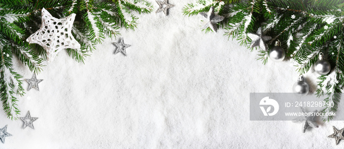 Christmas background, green pine branches, cones on snow background. Creative composition, top view.