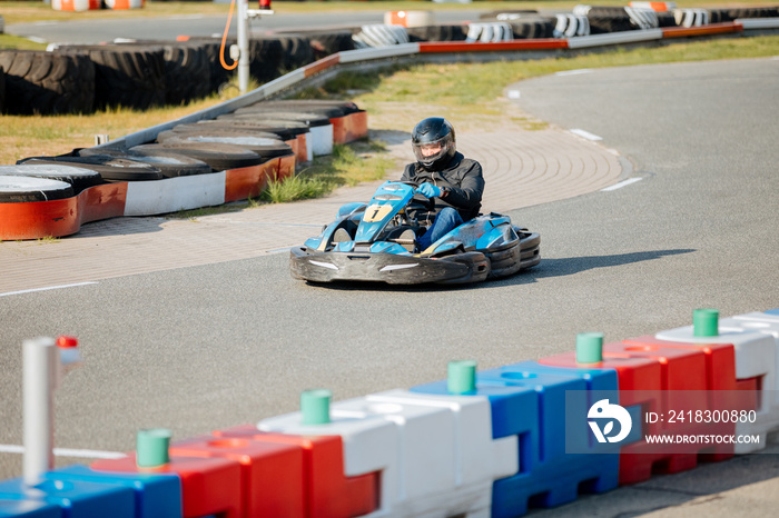 racing on the race. Male in a kart on a kart track. Man goes karting
