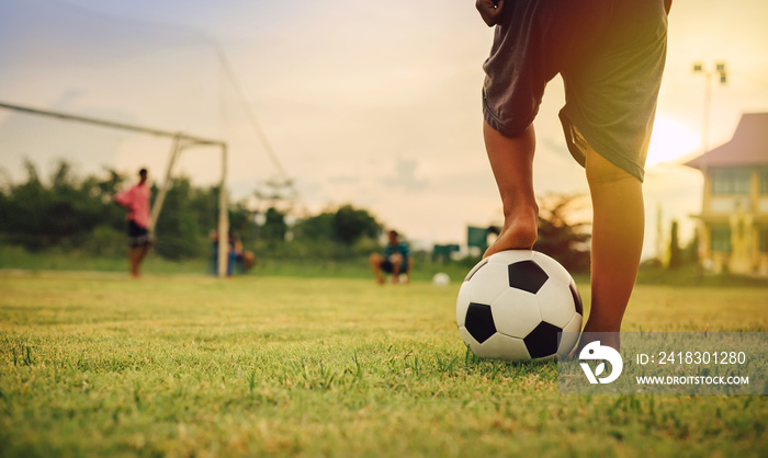 Action sport outdoors of kids having fun playing soccer football for exercise in community rural are