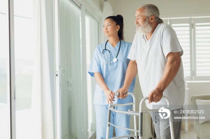 Healthcare worker with man using walking support