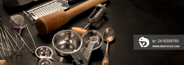 Set of kitchen utensils on black background. Tools for cooking.