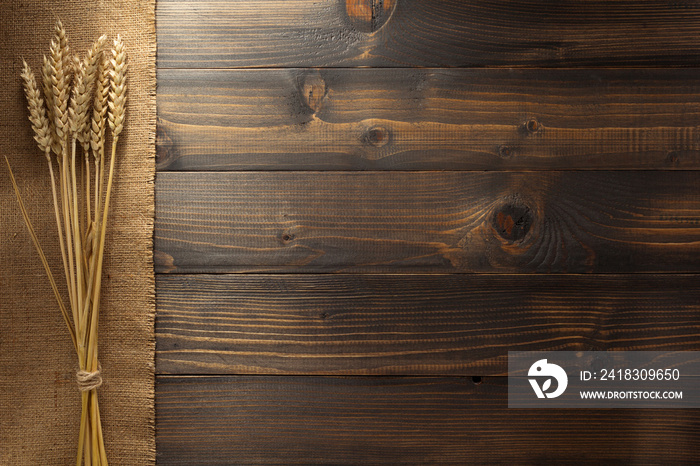 ears of wheat on wood