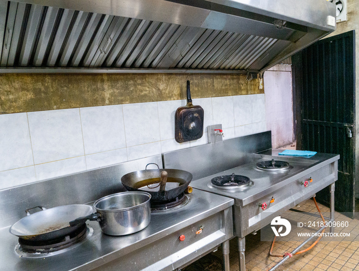 Kitchen with cooking equipment And the hood