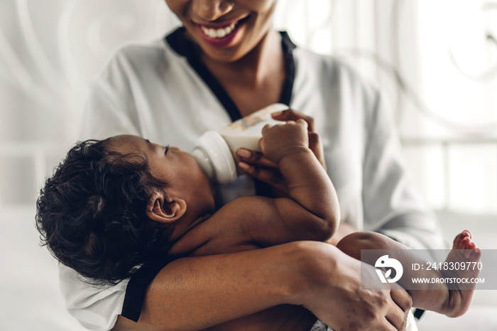 Portrait of enjoy happy love family african american mother playing with adorable little african ame