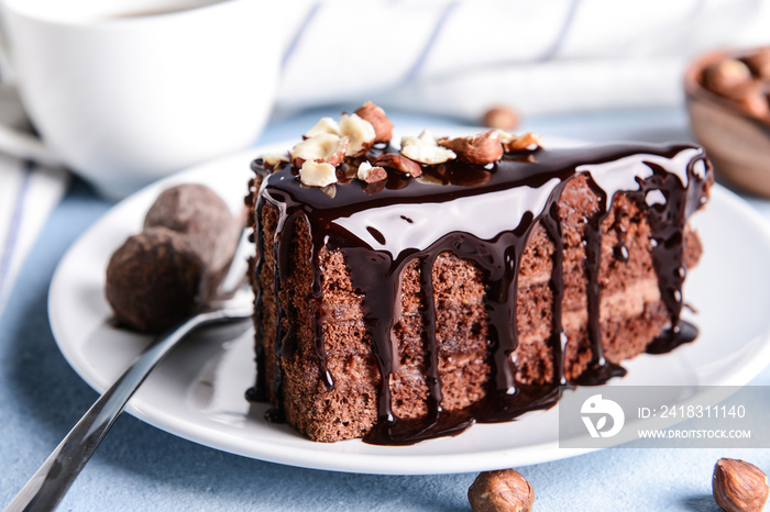 Plate with piece of tasty chocolate cake on table