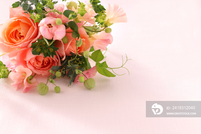 Beautiful spring bouquet of coral pink roses, sweet pea,  tulip flower, and green leaves.　ピンクのバラのブーケ