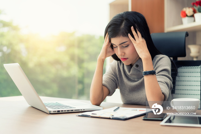 Portrait of tired young Asian business woman feeling stress from work. Stress at work and emotional 