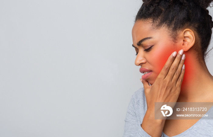 Sad young woman having wise teeth problem