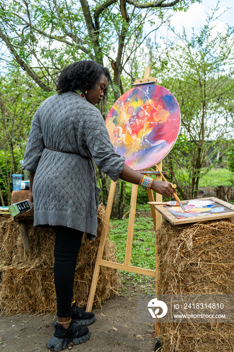 female artist working on an abstract painting