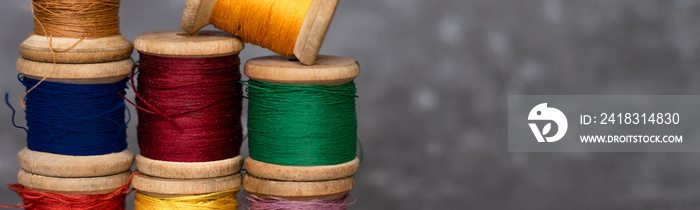 Different colorful cotton mill on grey background