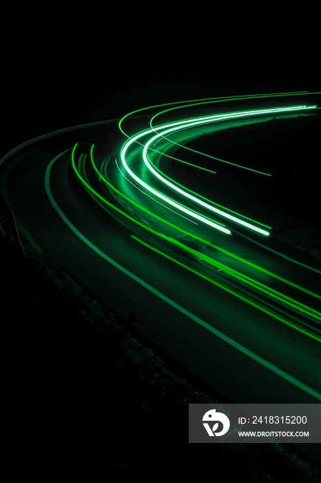 green car lights at night. long exposure