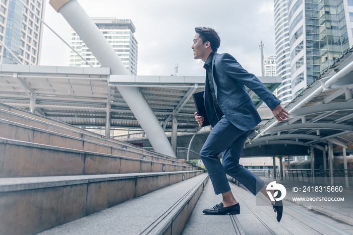 Businessman running up to stair in city,Growth of business concept