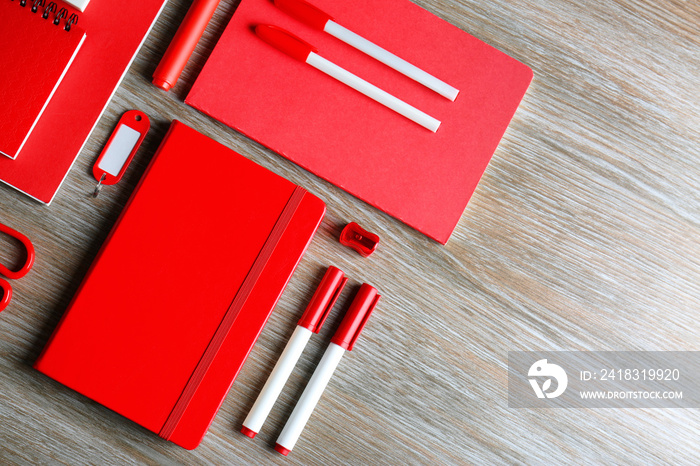 Flat lay of red stationery on wooden table