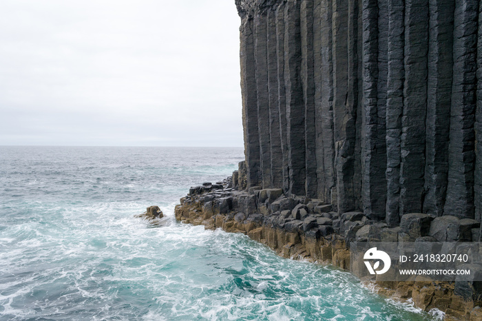The characteristic volcanic hexagon shaped stones and rocks of the little and wild Island of Staffa 