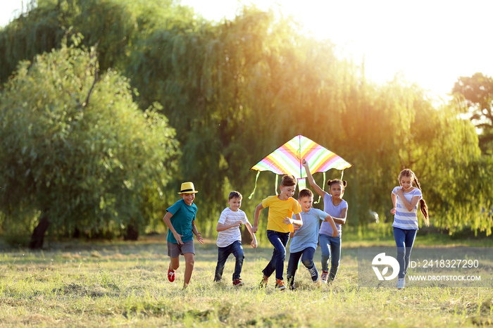 Children flying kite on summer day