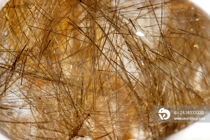 Macro mineral quartz hairy stone, quartz with rutile on a white background