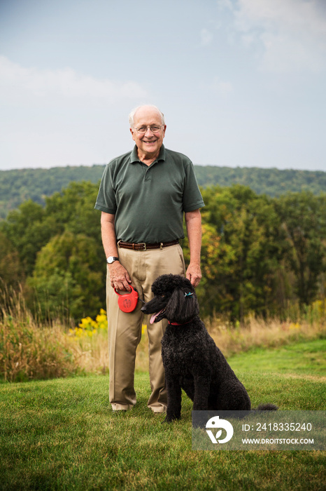 Senior man walking dog outside