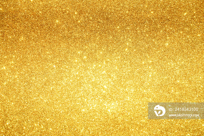 gold Sparkling Lights Festive background with texture. Abstract Christmas twinkled bright bokeh defo