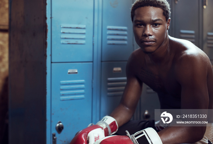 Portrait of man sitting in locker room