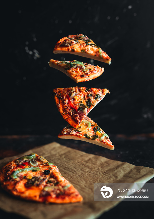 Levitation pizza on black background