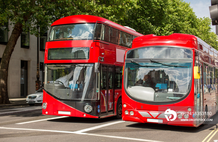 city street with red double decker buses in london