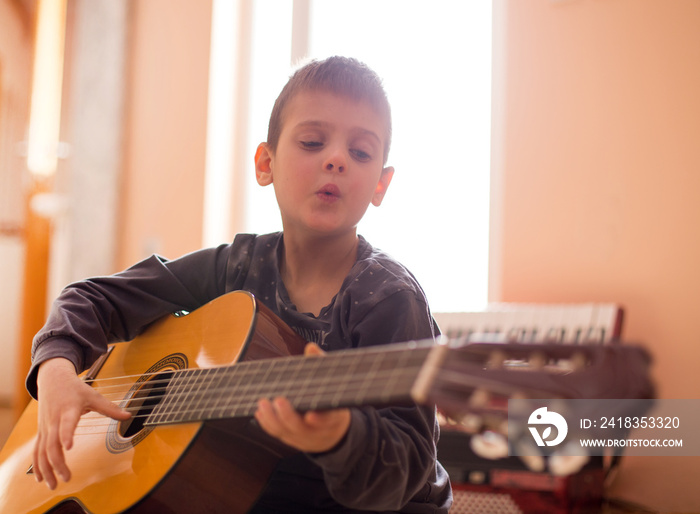 Boy enjoying playing guitar