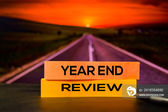 Year End Review on the sticky notes with bokeh background