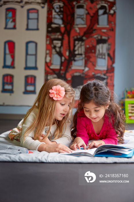 Children (4-5) looking at book