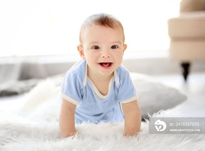 Little baby boy crawling on the floor at home