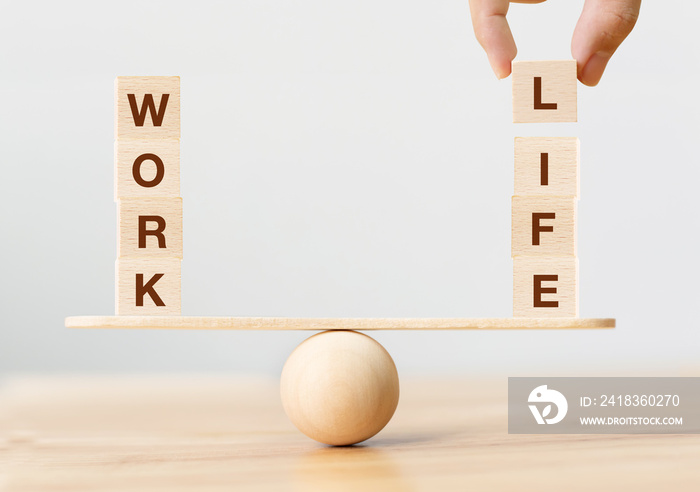 Work life balance concept. Wooden cube block with word WORK and LIFE on seesaw