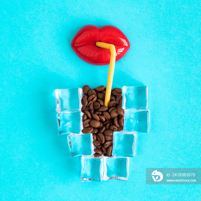 Lips toy with drinking straw and cup of ice coffee made of ice cubes and coffee beans.