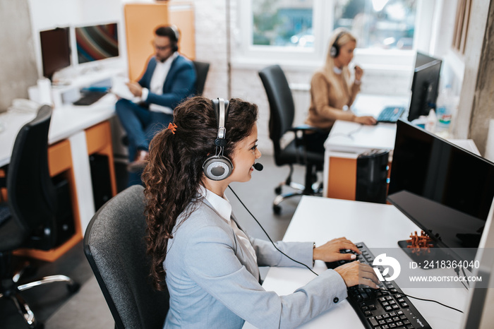 Team of call center employees working together on office.