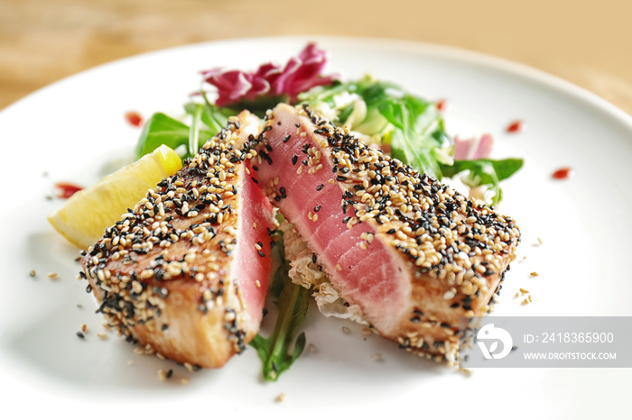 Plate with delicious tuna fillet on table, closeup