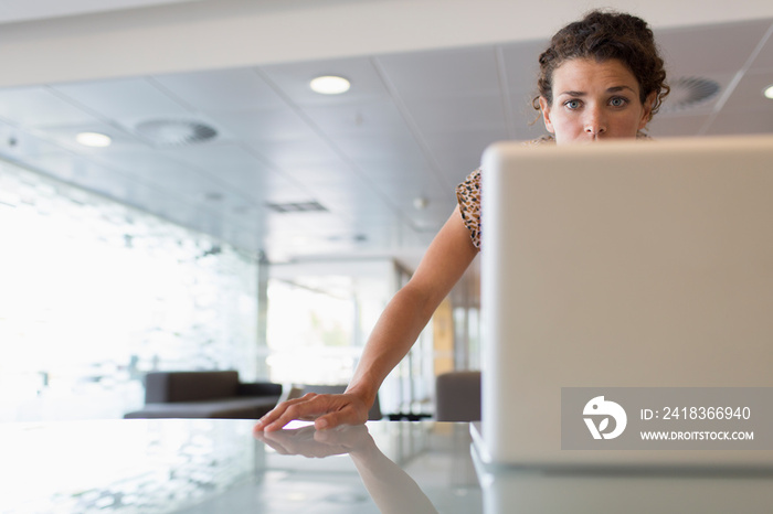 Businesswoman working at laptop in office