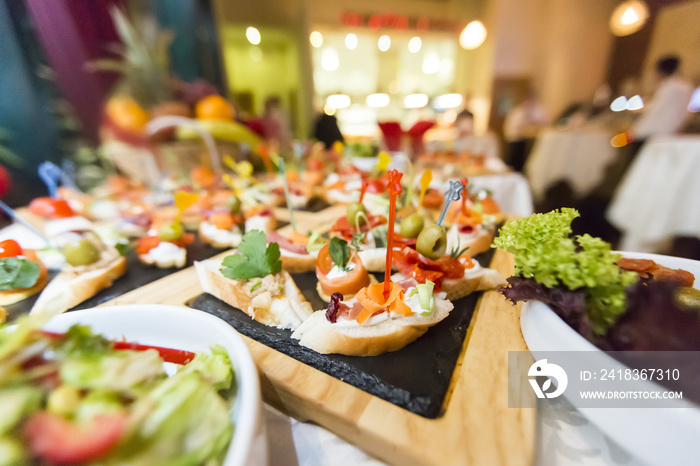 Beautifully decorated catering banquet table with different food snacks and appetizers