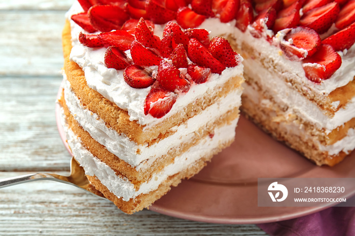 Taking of delicious strawberry cake from plate by using shovel, closeup