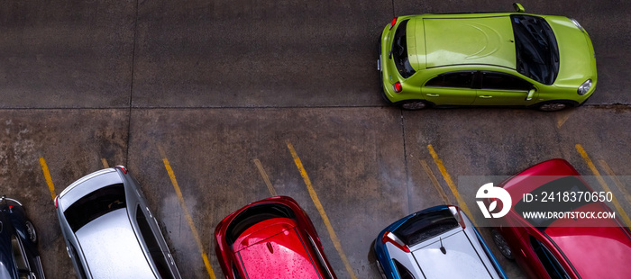 Top view of car parked at concrete car parking lot with yellow line of traffic sign on the street. A