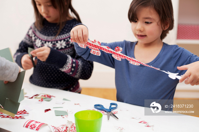 Girls making Christmas decorations