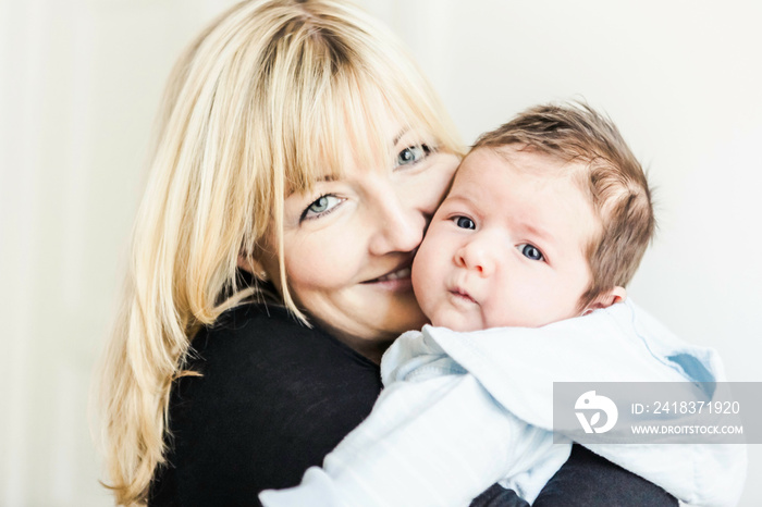 Portrait of mother holding baby boy