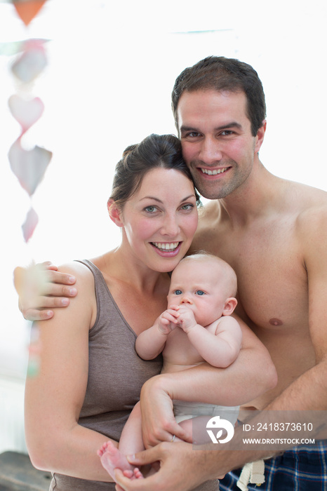 Portrait happy couple with baby daughter