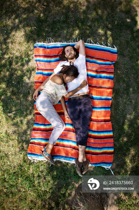 Young couple relaxing on blanket high angle view