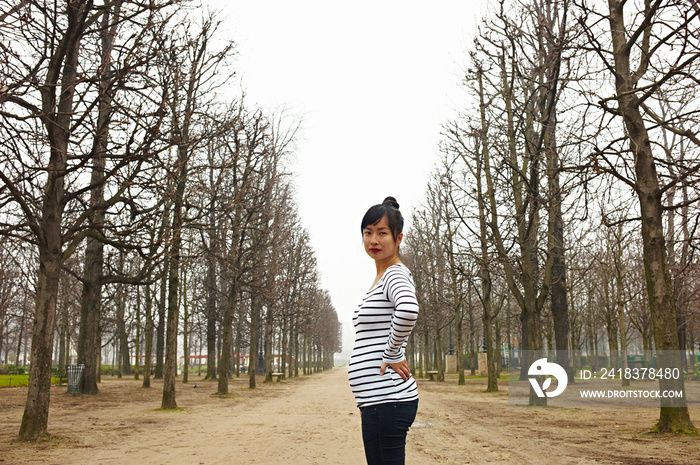 Woman in treelined avenue