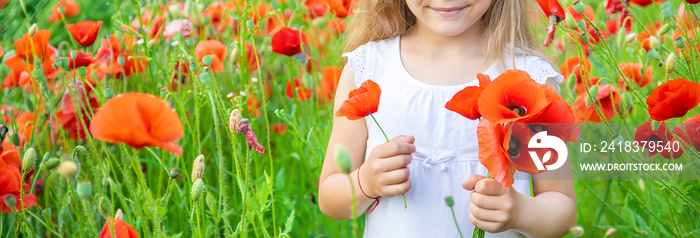 children girl in a field with poppies. selective focus.