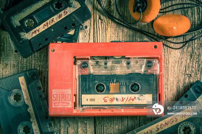 Vintage cassette tape with headphones and red walkman