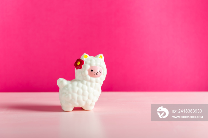 White Squishy Llama on bright pink background. Famous and popular kids toy.