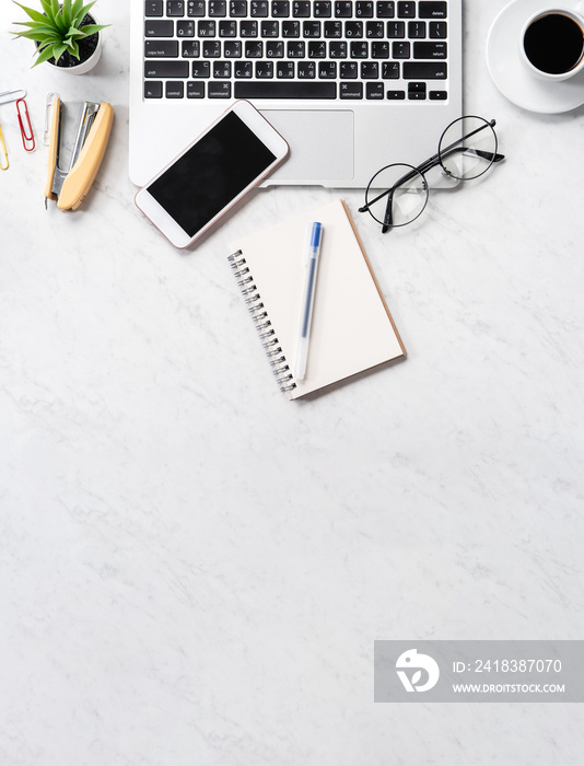 Stylized marble office working desk with smartphone, laptop, glasses and coffee, workspace design, m