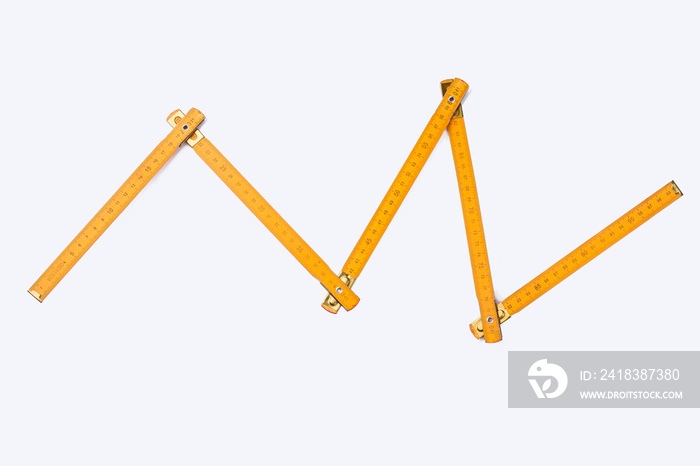 Folding ruler on white background. Image of yellow wooden yardstick. Carpenters tool with scale of n