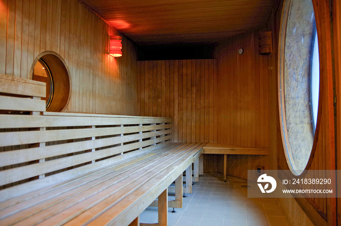 Finnish or dry sauna with oceanview or view of the sea inside male locker room of spa or wellness ar