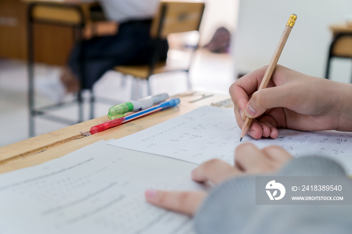 student taking notes lecture in high school or university with holding pencil writing on paperwork s