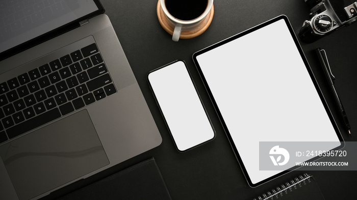 Modern dark workspace with laptop computer, smartphone and digital tablet mockup